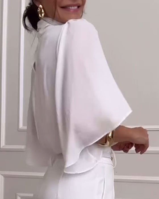 Blouse à manches papillon et col haut de couleur unie