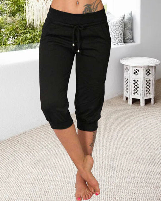 Pantalon à 3/4 longue avec poche de couleur unie