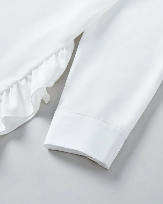 Chemise unie à volants et revers